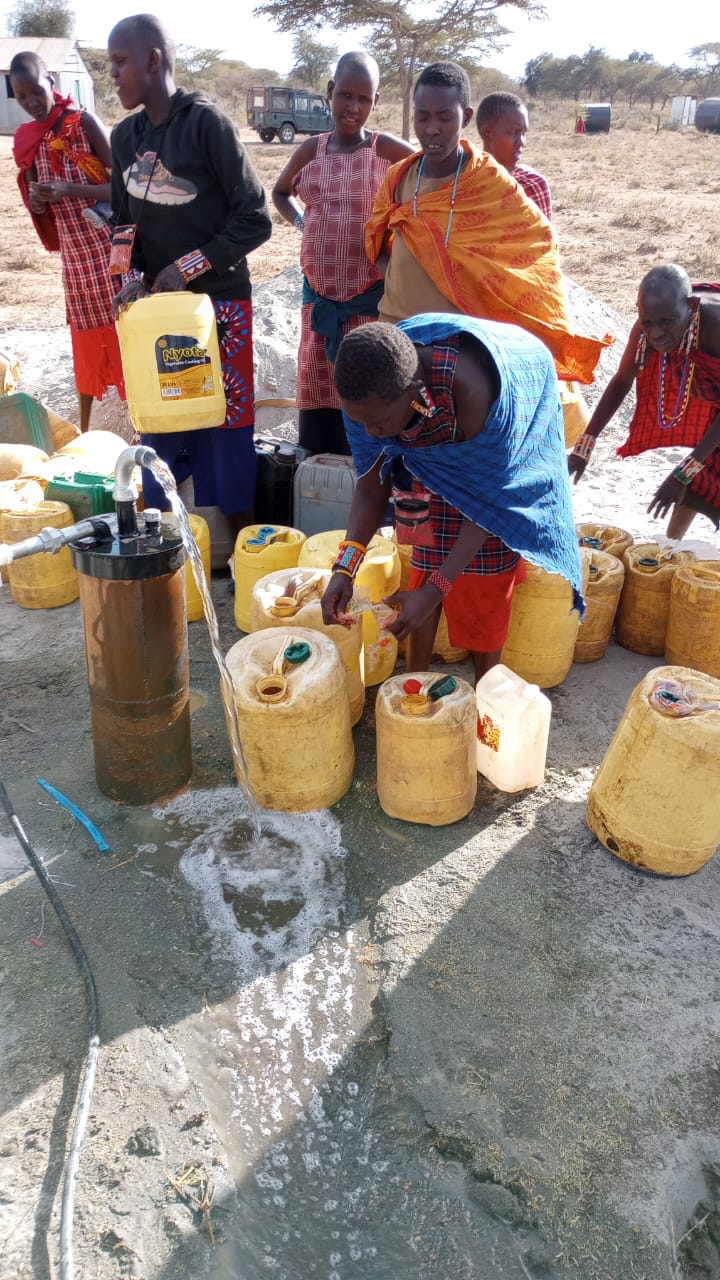 Maasai women and girls collecting safe drinking water at a newly commissioned Milimani borehole water point