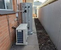 Domestic heat pump outdoor compressor unit installed at a residential property